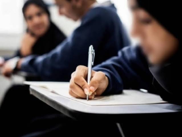 Students writing and discussing together during a Community session