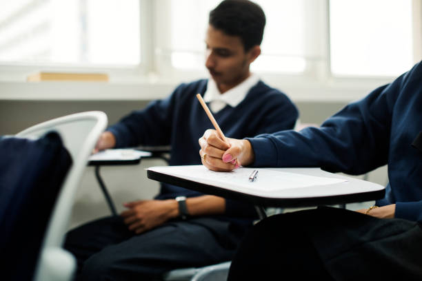 Students focused on writing and studying during a Community session